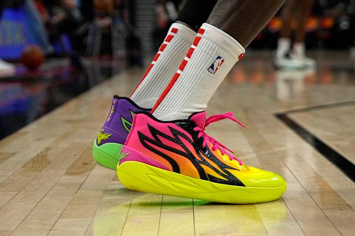 View of pink and yellow Puma shoes.